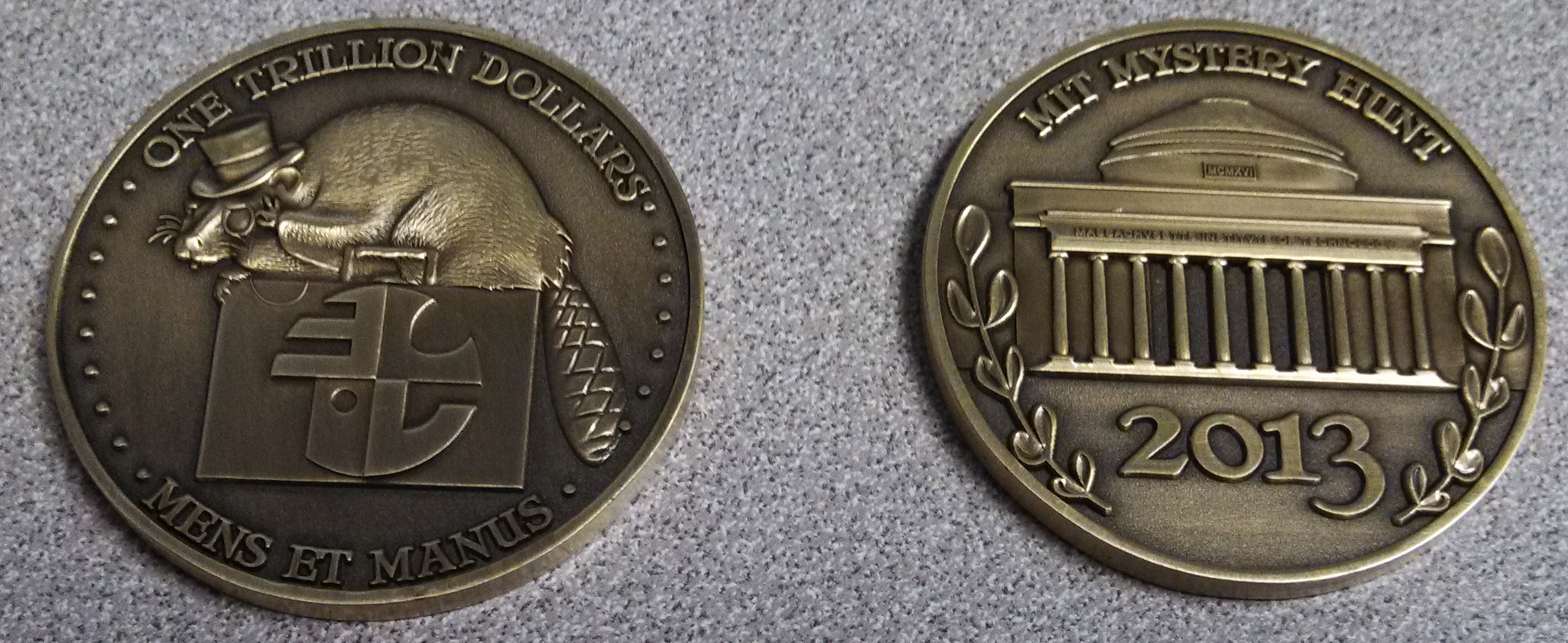 2013 hunt coin, with a monocle-and-top-hat-wearing beaver with an Enigma Valley briefcase on the front and building 26 on the back